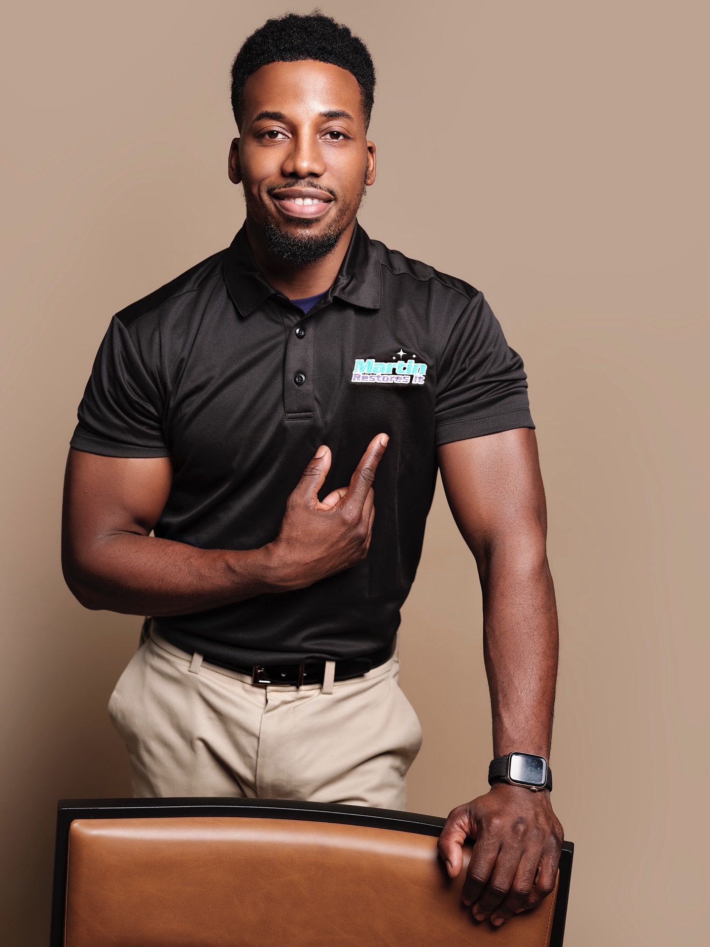 James Martin, owner of Martin Restores It, beside the company logo