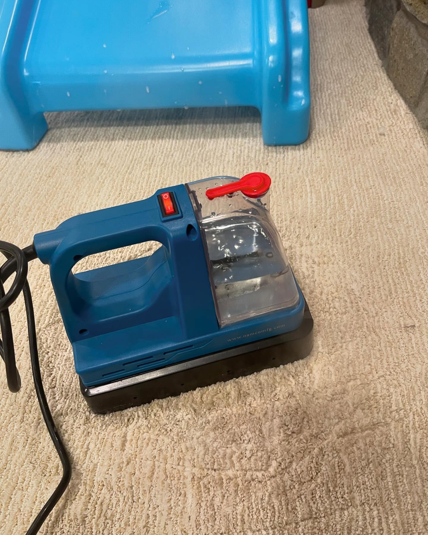 Heated carpet spotting machine sitting on the playroom carpet